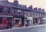 The Post Office (1984) is now the Pig and Pastry, and the Enterprise Shop is an McBride's Opticians. Len Cundall at the Post Office was famous for his dance band in York. (Photo: Rob Stay)